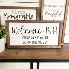 three wooden signs on a shelf with flowers in vases next to them and one sign that says, the most memorable welcome