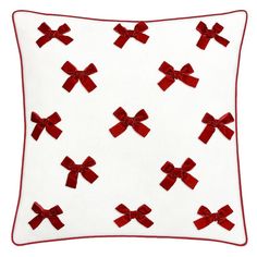 a red bow pillow on a white background