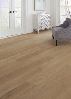 a living room with white walls and wood floors