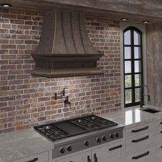 a stove top oven sitting inside of a kitchen next to a brick wall and window