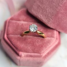 an engagement ring in a velvet box with a diamond on the top and bottom part