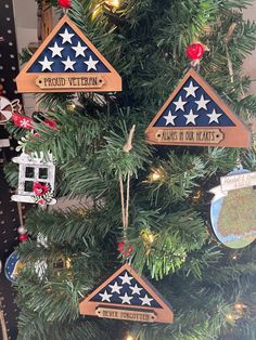 a christmas tree with ornaments hanging from it's sides and the words proud veteran on them