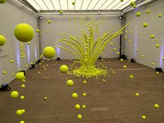 yellow balls are floating in an empty room