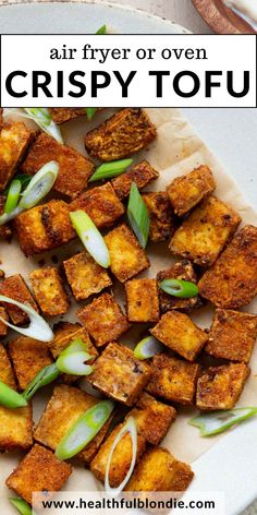 crispy tofu on a plate with onions and scallions