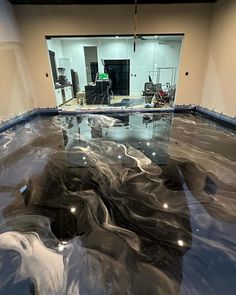 an indoor swimming pool is being installed in the middle of a building's floor