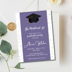 a purple graduation card with white stars and a black cap on it next to some flowers