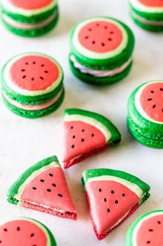 watermelon cookies with green frosting are arranged on a white surface