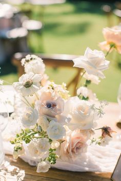 the table is set with white and pink flowers