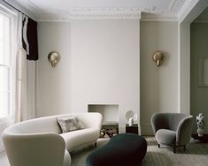 a living room filled with furniture and white walls