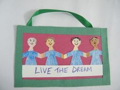 a paper bag with three people holding hands and the words live the dream written on it