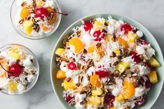 two bowls filled with fruit and nuts on top of a marble countertop next to another bowl