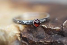 I made this cute little tiny stacker ring with genuine  4mm natural deep red garnet and solid sterling silver.  It would be a great addition to any of my stacking sets or worn alone.  The  stone, 4mm in size, sits inside the  sterling silver serrated bezel.  The band has a pretty "full moon floral" pattern  and is about 3.2 mm wide, and has been lightly antiqued and polished.  Note:  Other stones are available upon request (All genuine, natural stones):  amethyst, black onyx, black moonstone, ca Garnet Stackable Rings As A Gift, January Birthstone Rings, Black Moonstone, Stacker Rings, Garnet Gem, Stacking Ring Set, Black Onyx Ring, Garnet Ring, Red Band