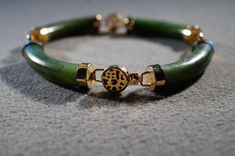 I am offering you this vintage sterling silver, with yellow gold overlay tennis style link bracelet. It features 4 total tubular oblong shaped genuine green jade stones. They are all set in a link setting, with Asian style motif designs. These stones have color saturation and intensity that is endless, as seen in the provided pictures. This measures app. 7 3/4 inches long, you may need this extra length due to the girth of this piece. What an eye catcher! This came out of an estate in upstate Ne Classic Jade Bracelet Jewelry, Classic Jade Bracelet, Tennis Design, Tennis Style, Vintage Tennis, Design Bracelet, Lock Style, Gold Overlay, Jade Bracelet