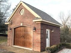 a brick building with two doors and a clock on the top of it's roof