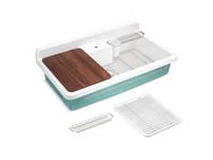 a kitchen sink with a cutting board and strainer next to it on a white background