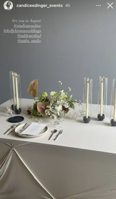 the table is set with candles and flowers