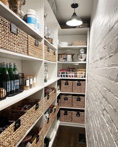 an organized pantry with baskets and wine bottles