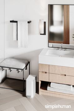 a bathroom with a sink, mirror and towel rack on the wall next to it