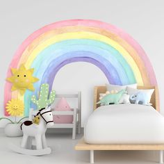 a child's bedroom decorated in pastel colors with a rainbow painted on the wall