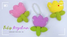 three crocheted keychains with flowers on them are shown in different colors