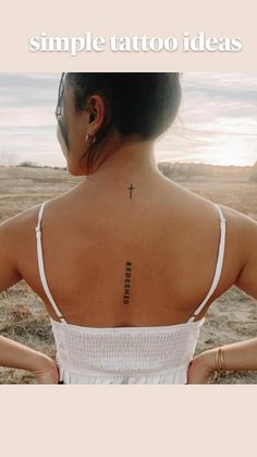 a woman with a cross tattoo on her back