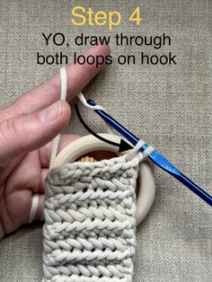 someone is crocheting an object with yarn on the hook and then knitting it