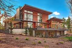 a large house with lots of windows in the woods