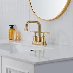 a bathroom with a sink, mirror and soap dispenser on the counter