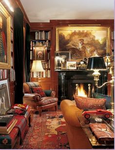 a living room filled with lots of furniture next to a fire place and bookshelf