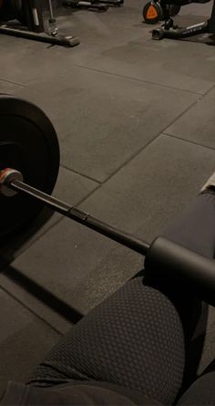 a man is lifting a barbell in the gym