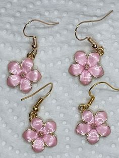 These sweet pink flower charms are edged in gold, the center is a sparkly faceted pink crystal rhinestone.  Tge base is gold tone.  Beautifully detailed, these are lightweight, delicate little earrings.  suitable for younger girls.  I added nickel free gold tone ear wires. All  materials used are nickel free. Please feel free to reach out with any questions. I ship daily Mon-Fri except holiday, with tracking in USA only  PLEASE NOTE: local regulations do not allow returns or exchanges of pierced jewelry. Pink Cottage Core, Cottage Core Earrings, Cottage Core Fairy, Pink Cottage, Pierced Jewelry, Fairy Core, Earrings Dainty, Flower Charm, Pink Crystal