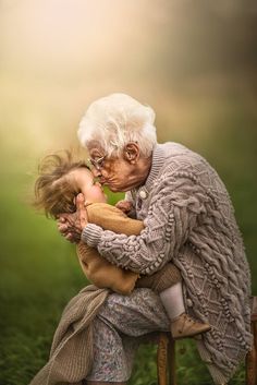 an old woman holding a child in her arms with the caption's name on it