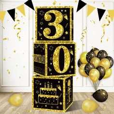 a black and gold 30th birthday cake with balloons in the background, surrounded by confetti and streamers