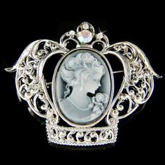 "PERFECT CHRISTMAS / VALENTINE / MOTHER'S DAY GIFT !! PERFECT GIFT /WEDDING GIFT FOR BRIDE / BRIDESMAID / LADY! This Classy Black Cameo Crown pin /brooch measuring 2 1/8\" wide X 1 5/8\" high (53mm X 42mm), inlayed with a lot of Swarovski crystals. Crystal Color: Aurora Borealis, Crystal Clear It goes well with modern as well as vintage styling...it really depends how you want to wear it. Great piece for your collection! Prices are in US$. For shipping policies and other important information, c Cameo Brooches For Wedding, Elegant Silver Brooch For Christmas, Victorian White Wedding Brooches, Ornate White Brooches For Wedding, White Ornate Wedding Brooches, Ornate White Wedding Brooches, White Cameo Brooch For Wedding, Victorian Silver Wedding Brooches, White Cameo Brooches For Wedding