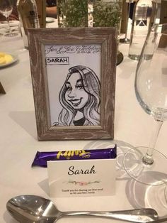 a table with silverware, spoons and a framed photo on it next to a bar of chocolate