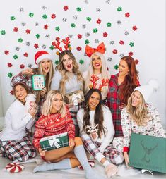 a group of women in christmas pajamas posing for a photo