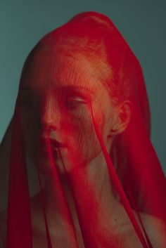 a woman's face is covered in red light