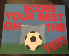 a sign that says score your best on the test with a soccer ball in front of it