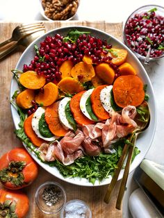 a white plate topped with meat and veggies on top of a wooden table