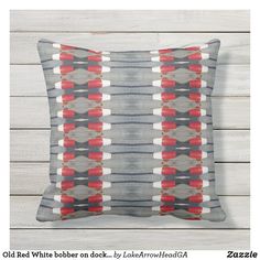 an old red white and blue pillow on a wooden background with text overlay that says old white bobber check - by lakewood road