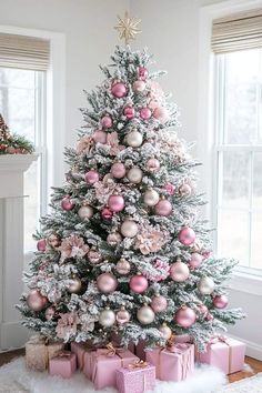 a decorated christmas tree with pink and silver ornaments