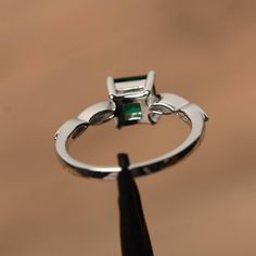 It is a lab emerald ring, princess cut, measures 6mm*6mm, weight about 0.93 cts. The basic metal is sterling silver and plated with rhodium. To change the metal to a solid gold (white/rose) or platinum is also available, please ask for a quotation if you want. You can also go to my shop Home for more elegant rings: https://www.etsy.com/shop/godjewelry?ref=hdr_shop_menu emerald is May birthstone More emerald rings: https://www.etsy.com/shop/godjewelry?ref=seller-platform-mcnav&section_id=2070 Emerald Promise Rings, Ring Princess Cut, Rings Green, Elegant Rings, May Birthstone Rings, Emerald Rings, Birthstone Rings, Rings Sterling Silver, May Birthstone