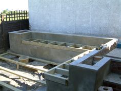 an unfinished pool being built in front of a house with concrete walls and flooring