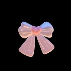 two pink bows with hearts on them against a black background