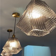 three clear glass lamps hanging from the ceiling