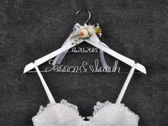 a wedding bra hanging on a hanger