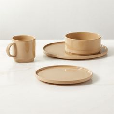 three plates and two cups on a table