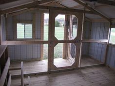 the inside of a chicken coop with doors open