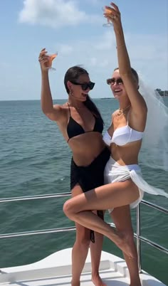 two women on a boat posing for the camera