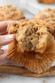 a person holding a muffin in their hand